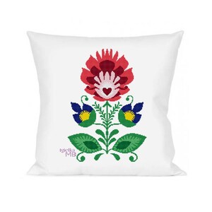 May include: White square pillow featuring a vibrant floral design. The design includes a large red flower with a heart-shaped center, blue and yellow flowers, and green leaves. The pillow has the text "Igielka MB" in the bottom left corner.
