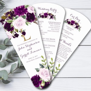 May include: Purple and white floral wedding program fan with the text "The Wedding Ceremony of Julia Stephenson and Garrett Lemieux" and the date "April 12, 2019, Ocho Rios, Jamaica".