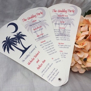 May include: A wedding program fan with a blue and white palm tree design. The text on the fan reads "The Wedding Ceremony of Nicholas Robert and Melissa Ann".