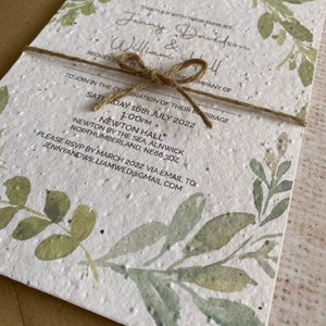 May include: A white wedding invitation with green watercolor leaves and the text "Together with their families Jenny Davidson & William Hall Request the pleasure of your company... Saturday 16th July 2022 1:00pm Newton Hall Newton by the Sea, Alnwick Northumberland, NE66 3DZ Please RSVP by March 2022 via email to: jennyandwilliamwed@gmail.com"