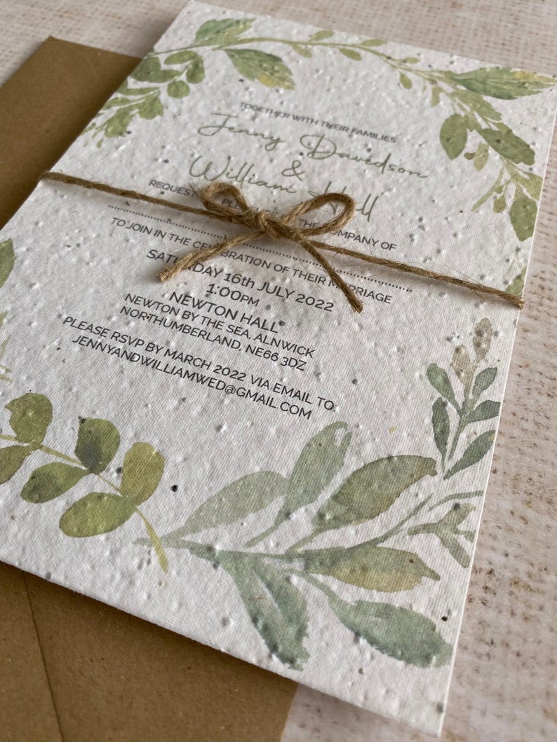 May include: A white wedding invitation with green watercolor leaves and the text "Together with their families Jenny Davidson & William Hall Request the pleasure of your company... Saturday 16th July 2022 1:00pm Newton Hall Newton by the Sea, Alnwick Northumberland, NE66 3DZ Please RSVP by March 2022 via email to: jennyandwilliamwed@gmail.com"