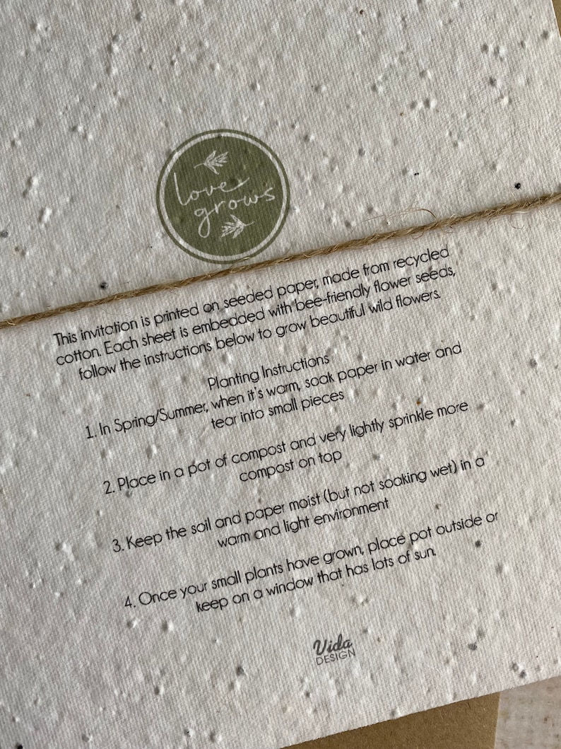 May include: A close-up of a light brown paper invitation with the text "love grows" in a green circle. The paper is made from recycled cotton and embedded with bee-friendly flower seeds. The instructions for planting the seeds are listed below.