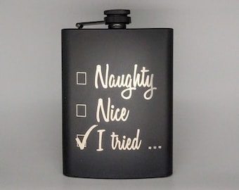 Może przedstawiać: Czarna metalowa butelka z białym napisem "Naughty, Nice, I tried..." z zaznaczonym haczykiem przy "I tried".