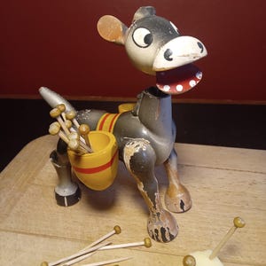 1950s kitsch wooden mule holding cocktail picks. Nodding head Muffin the Mule type.