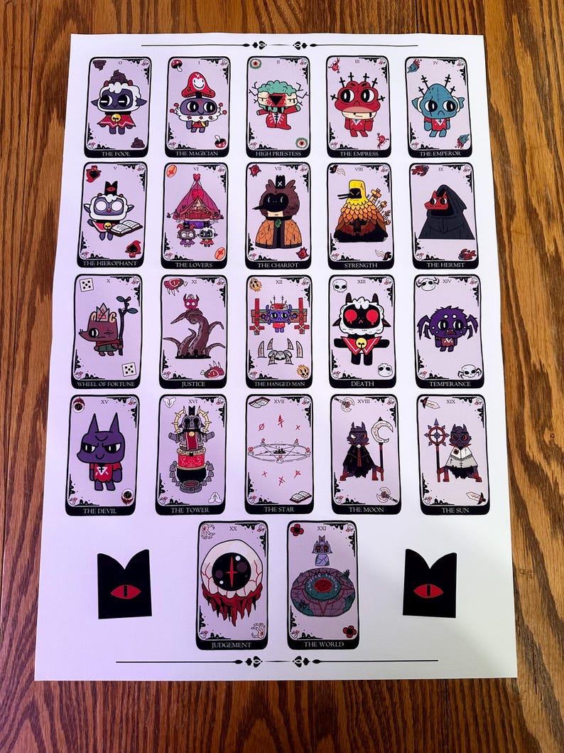 May include: A set of 22 tarot cards featuring illustrations of various characters and symbols. The cards are printed on white paper with a light pink background. The cards are arranged in a grid pattern, with each card having a black border. The cards are numbered from 0 to 21, and each card has a name printed on it. The cards are all in the same style, with a cartoonish aesthetic.
