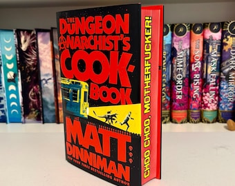 El libro de cocina del anarquista de la mazmorra con bordes personalizados pintados a mano con plantillas.