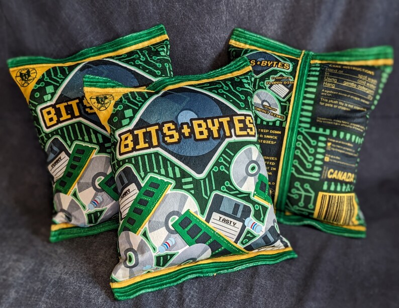 May include: Three green and yellow pillow-shaped chip bags with the text "Bits + Bytes" and a circuit board design. The bags are filled with a snack.