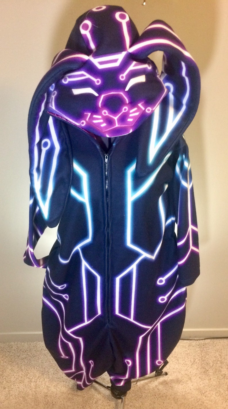 May include: A black hooded jumpsuit with a zip fastening and a neon purple and blue circuit board design. The hood has bunny ears.