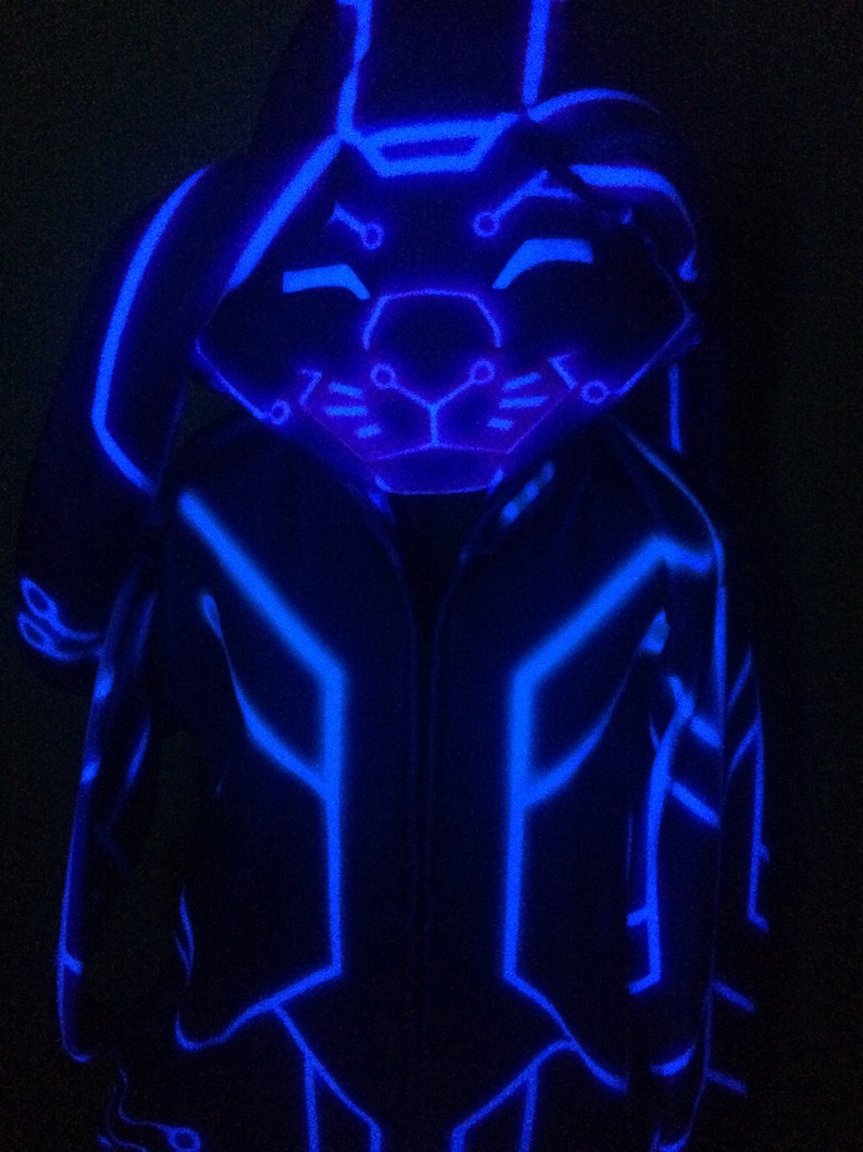 May include: A blue glow-in-the-dark hooded jacket with a geometric pattern. The hood has a bunny face design.