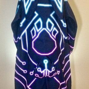 May include: A black hooded sweatshirt with a neon blue and purple circuit board design. The hood has two bunny ears.