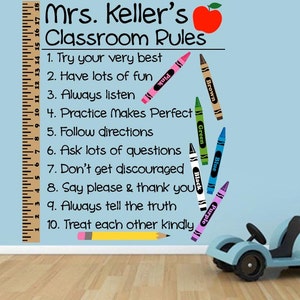 May include: Classroom rules poster with a red apple and a ruler. The rules are written in black text and include: Try your very best, Have lots of fun, Always listen, Practice makes perfect, Follow directions, Ask lots of questions, Don't get discouraged, Say please & thank you, Always tell the truth, Treat each other kindly.