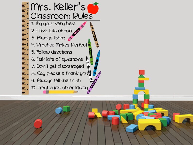 May include: Classroom rules poster with a red apple and a ruler. The rules are written in black text and include: Try your very best, Have lots of fun, Always listen, Practice makes perfect, Follow directions, Ask lots of questions, Don't get discouraged, Say please & thank you, Always tell the truth, Treat each other kindly.