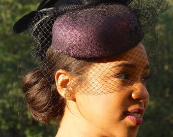 Aubergine Iridescent Leather pillbox. Perfect Ascot Derby Race Day. Hat with black crinoline, Black veiling and iridescent rooster feathers.