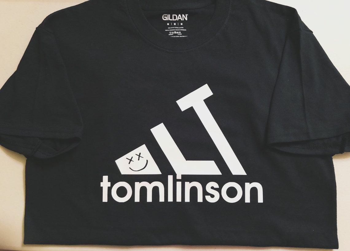 Louis Tomlinson merch, a black tshirt that says "LT" and tomlinson at the bottom