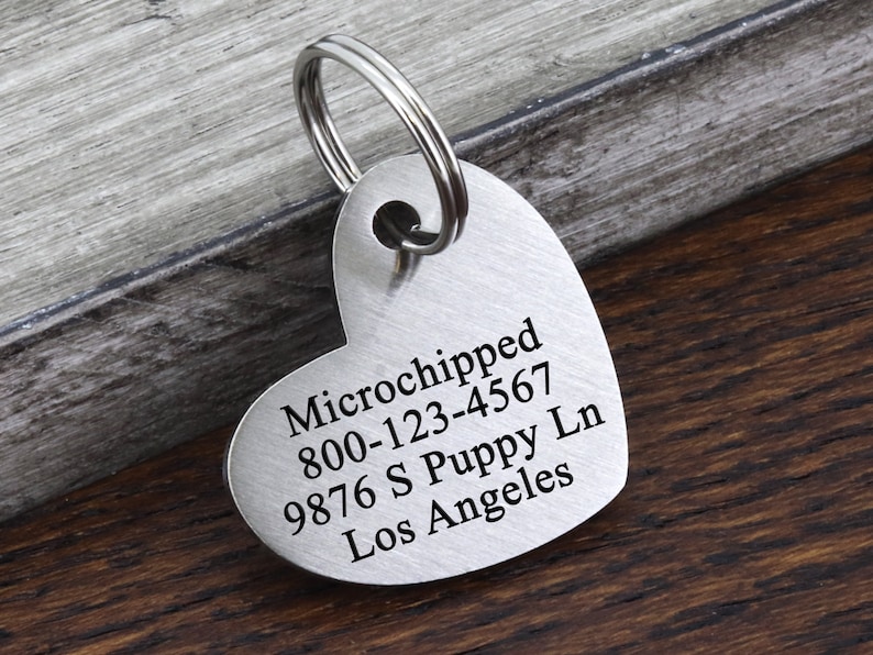 May include: Silver heart-shaped pet ID tag with engraved text: "Microchipped 800-123-4567 9876 S Puppy Ln Los Angeles"