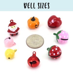 May include: Assortment of small jingle bells in various colours and designs, including a pumpkin, a heart, a strawberry, a Santa Claus, and a plain bell. The bells are shown next to a US quarter for size comparison.