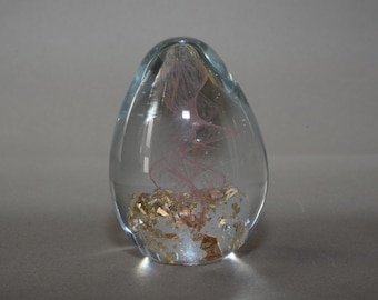 Vintage glass paperweight with gold flakes and pink swirl
