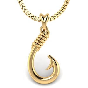May include: A gold-colored pendant necklace featuring a detailed fish hook design. The hook is coiled at the top and has a smooth, curved shape.