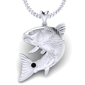 May include: A silver fish pendant with a black gemstone eye. The pendant is attached to a silver chain.