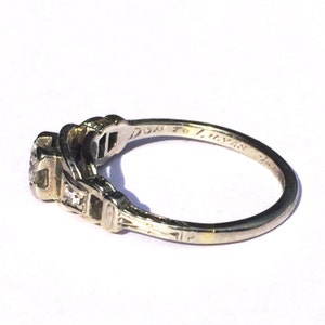 May include: A silver ring with a central diamond and smaller diamonds on the band. The inscription on the inside of the band reads "Don to Tristan".