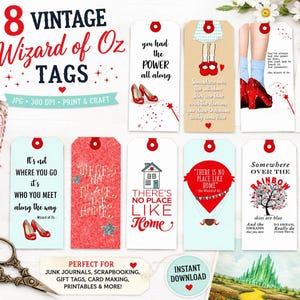 May include: A set of eight rectangular paper tags featuring Wizard of Oz themes, including illustrations of red shoes, a hot air balloon, and text quotes. The tags are white, light blue, and red with various typography and decorative star accents.