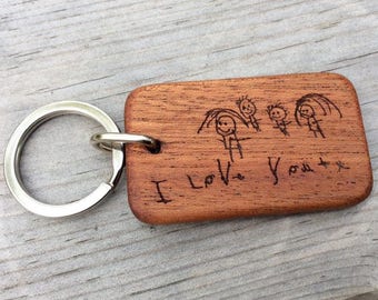 May include: A wooden keychain with a drawing of a family and the words "I Love You" engraved on it.