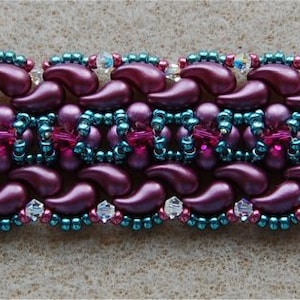 May include: A beaded bracelet with a silver clasp. The bracelet is made with purple, teal, and clear beads in a repeating pattern.