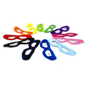 May include: A set of ten colorful felt superhero masks arranged in a circle. The masks are all the same shape, but each one is a different color, including red, orange, yellow, green, blue, purple, pink, black, and white.