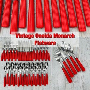 May include: Vintage Oneida Monarch Flatware set with red plastic handles. The set includes forks, knives, and spoons.