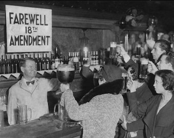 May include: A group of people in a pub celebrating the repeal of the 18th Amendment, also known as Prohibition, with a sign that reads "Farewell 18th Amendment". They are raising glasses of beer in a toast.