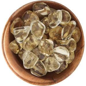 May include: A wooden bowl filled with polished, translucent citrine gemstones. The stones vary in size and shape, displaying shades of yellow and brown. The bowl is made of light brown wood.