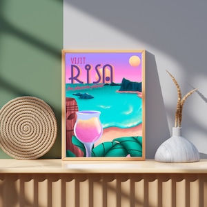 May include: A framed poster featuring a tropical beach scene. The poster reads "Visit Risa, the paradise place" and depicts a pink drink in a glass, a tiki statue, and a sunset.