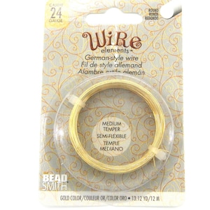 Peut inclure: Un paquet de fil de style allemand de calibre 24 de couleur or. L'emballage comprend un cercle en plastique transparent contenant le fil, avec du texte indiquant qu'il est de dureté moyenne et semi-flexible. La marque "Bead Smith" est également présente.