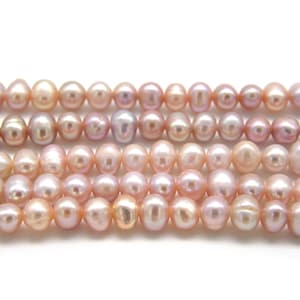May include: A strand of pink and purple freshwater pearls. The pearls are round and have a smooth, lustrous finish.