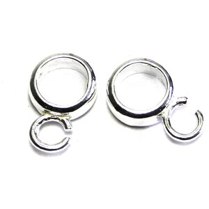 Puede incluir: Dos anillos de salto plateados con un bucle soldado en cada uno. Los anillos de salto son redondos y tienen un acabado liso.