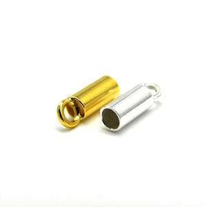 May include: Two metal end caps for jewelry making. One is gold and the other is silver.