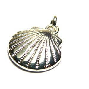 May include: A silver-colored seashell pendant with a detailed, ridged surface. The pendant has a loop at the top for attaching to a chain or cord. The design is a classic nautical theme.