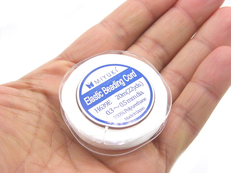 May include: A white spool of elastic beading cord labeled "MIYUKI Elastic Beading Cord H639E 20m(22yds) 03~0.5mm dia 100% Polyurethane Made in Japan"
