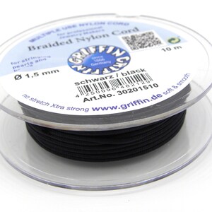 May include: A spool of 1.5 mm black braided nylon cord, 10 meters long. The cord is labeled "schwarz/black" and "Art.No. 30201510". It is described as "no stretch Xtra strong" and "soft & smooth".
