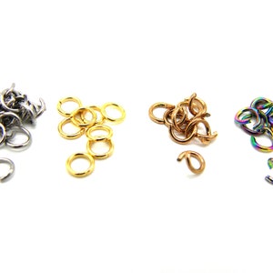 Puede incluir: Surtido de anillas de salto en cuatro colores diferentes: plata, oro, cobre y arcoíris. Las anillas de salto son pequeñas y son ideales para la elaboración de joyas.