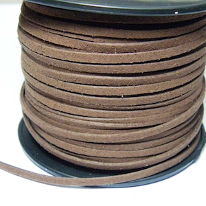May include: A spool of brown leather cord. The cord is wound tightly around the spool and is ready to be used for crafting projects.
