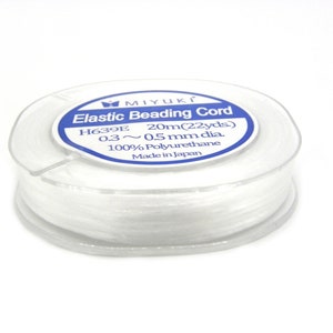 May include: A spool of white elastic beading cord, labeled "MIYUKI Elastic Beading Cord H639E 20m(22yds) 0.3~0.5 mm dia. 100% Polyurethane Made in Japan"