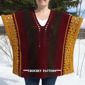 May include: Crochet poncho with a striped pattern in burgundy, brown, and gold. The poncho has a v-neck and a crocheted lace trim. The text "***CROCHET PATTERN***" is visible on the poncho.