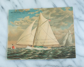 May include: A vintage postcard featuring a colorful illustration of two sailboats on the water. The text on the postcard reads "MANUFACTURED BY / Bora, Chen, Baldwin, Trucks & Schmidt / 214 West Water Street, UTICA, N.Y."