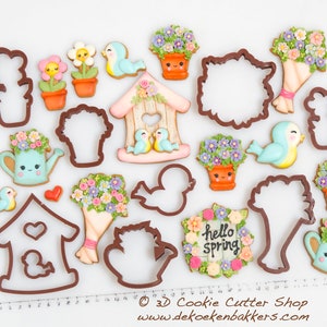 May include: A set of 15 cookie cutters featuring spring-themed designs, including a birdhouse, flowers, birds, watering cans, and a wreath that says "hello spring".