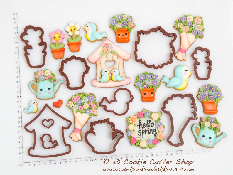 May include: A set of 15 cookie cutters featuring spring-themed designs, including a birdhouse, flowers, birds, watering cans, and a wreath that says "hello spring".