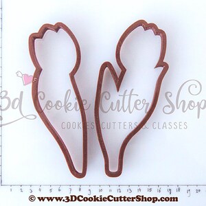 May include: Two brown plastic cookie cutters shaped like tulips. The cutters are approximately 8 cm tall and 3 cm wide.