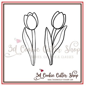 May include: A black and white line drawing of two tulips with stems and leaves. The image is on a white background with the text "3d Cookie Cutter Shop" in black and red.