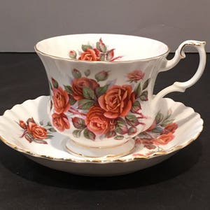 Vintage Royal Albert Bone China England Centenial Rose With Gold Edging Tea Cup And Saucer.