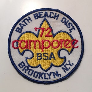 May include: A blue and white embroidered patch with a yellow scout emblem. The text on the patch reads "Bath Beach Dist 72 camporee BSA Brooklyn, NY."